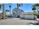 A luxurious home with a brick driveway and a two-car garage provides ample parking space at 732 Siesta Dr, Sarasota, FL 34242