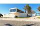 Exterior shot of the Siesta Beach architecture with modern design and nearby palm trees at 732 Siesta Dr, Sarasota, FL 34242