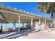 Exterior view of Siesta Beach pavilion with picnic tables and information station at 732 Siesta Dr, Sarasota, FL 34242