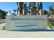 Exterior shot of the Siesta Beach sign with palm trees and blue sky in the background at 732 Siesta Dr, Sarasota, FL 34242