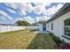 View of fenced backyard and exterior of home with dark trim at 7516 22Nd W Ave, Bradenton, FL 34209