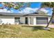 Lovely single-story home with lush lawn, gray garage door, and tasteful landscaping at 7516 22Nd W Ave, Bradenton, FL 34209