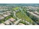 Aerial view of a residential area with a lake and lush greenery, creating a serene and picturesque environment at 7649 Quinto Dr, Sarasota, FL 34238