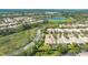 Stunning aerial view of a residential community with a lake, surrounded by lush greenery and well-maintained homes at 7649 Quinto Dr, Sarasota, FL 34238