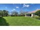 Lush, green backyard with plenty of open space and manicured hedges, perfect for outdoor enjoyment at 7649 Quinto Dr, Sarasota, FL 34238