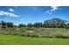 Beautiful backyard view featuring a serene landscape with trees and a tranquil water feature at 7649 Quinto Dr, Sarasota, FL 34238