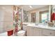 Bathroom with a tub-shower combination featuring bright and colorful floral shower curtain at 7649 Quinto Dr, Sarasota, FL 34238