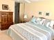 Bedroom with a wooden dresser and matching nightstand, queen size bed, and mirrored closet at 7649 Quinto Dr, Sarasota, FL 34238