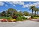 Welcoming community entrance with colorful flowers, lush landscaping, and signage for a positive first impression at 7649 Quinto Dr, Sarasota, FL 34238