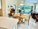 Bright dining area featuring a wooden table and chairs, with a view of the outdoor patio at 7649 Quinto Dr, Sarasota, FL 34238