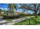 Beautiful property showcasing a meticulously maintained lawn, mature landscaping, and a welcoming facade at 7649 Quinto Dr, Sarasota, FL 34238