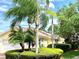 Charming single-story home exterior with well-maintained landscaping, including mature trees and lush greenery at 7649 Quinto Dr, Sarasota, FL 34238