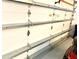 View of garage interior with garage door hardware; the perfect place to park a car or store belongings at 7649 Quinto Dr, Sarasota, FL 34238