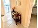 Inviting hallway features tile flooring, a decorative console table, and views into adjacent rooms at 7649 Quinto Dr, Sarasota, FL 34238