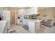 Bright kitchen with white cabinets, tile floors, and open access to adjacent living spaces at 7649 Quinto Dr, Sarasota, FL 34238