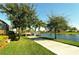 Picturesque view of a manicured pathway leading to a bridge over a tranquil lake at 7649 Quinto Dr, Sarasota, FL 34238