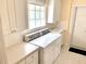 Bright laundry room features a washer and dryer and a glass block window for added natural light at 7649 Quinto Dr, Sarasota, FL 34238