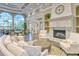 Comfortable lounge area with fireplace, neutral tones, large windows, and views of the community at 7649 Quinto Dr, Sarasota, FL 34238