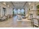 Elegant lounge area with coffered ceiling, fireplace, large windows, and tables with seating at 7649 Quinto Dr, Sarasota, FL 34238