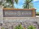 Community sign at Palmer Ranch with stone base and manicured landscaping at 7649 Quinto Dr, Sarasota, FL 34238