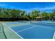 Community tennis court featuring well-maintained surface and shade for the players at 7649 Quinto Dr, Sarasota, FL 34238