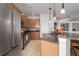 View of the kitchen with granite countertops, stainless steel appliances, wooden cabinets and tile floors at 7951 113Th Avenue E Cir, Parrish, FL 34219