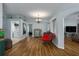 Open floorplan living room with wood floors, chandelier, and easy access to the laundry room at 7951 113Th Avenue E Cir, Parrish, FL 34219