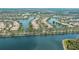 Expansive aerial view highlighting waterfront homes in a tranquil community setting at 8300 Jesolo Ln, Sarasota, FL 34238