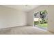 Bright bedroom with a large sliding glass door leading to a landscaped backyard at 8300 Jesolo Ln, Sarasota, FL 34238