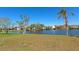 Scenic backyard view featuring lush lawn with waterfront access to a tranquil lake at 8404 43Rd W Ave, Bradenton, FL 34209