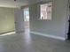 Open living space with tiled flooring, large windows and freshly painted walls at 8503 Dorothy Ave, North Port, FL 34287