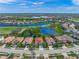 Stunning aerial view of the home in a lakeside community with lush greenery and a neighborhood pool at 8956 Stone Harbour Loop, Bradenton, FL 34212