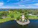 Scenic aerial view of a community park with a charming lighthouse on a small island at 8956 Stone Harbour Loop, Bradenton, FL 34212