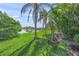 Tranquil backyard with lake view, swing set, and lush green lawn at 8956 Stone Harbour Loop, Bradenton, FL 34212