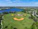Community baseball field with lights surrounded by lake and foliage creating a lovely atmosphere at 8956 Stone Harbour Loop, Bradenton, FL 34212