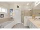 Bathroom showcasing a soaking tub, glass shower, and dual sink vanity at 8956 Stone Harbour Loop, Bradenton, FL 34212