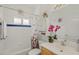Cozy bathroom with shower-tub combo, white cabinets, colorful floral shower curtain, and coordinated décor at 8956 Stone Harbour Loop, Bradenton, FL 34212