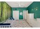 Bedroom featuring green walls, closet, dresser, forest scene and zig-zag rug at 8956 Stone Harbour Loop, Bradenton, FL 34212