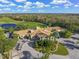 Beautiful aerial view of the clubhouse with convenient golf cart parking and lush landscaping at 8956 Stone Harbour Loop, Bradenton, FL 34212