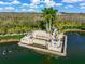 Aerial view of the beautiful Heritage Harbour entrance with mature palm trees and serene water features at 8956 Stone Harbour Loop, Bradenton, FL 34212
