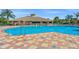 Beautiful community pool with tile deck and lounge chairs surrounded by lush landscaping at 8956 Stone Harbour Loop, Bradenton, FL 34212