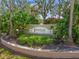 Community entrance sign with lush landscaping and elegant design creating a welcoming first impression at 8956 Stone Harbour Loop, Bradenton, FL 34212