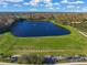 Aerial shot of a community lake with palm trees, green space, and walking paths at 8956 Stone Harbour Loop, Bradenton, FL 34212