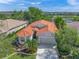 Aerial view of the house showcasing its tile roof, landscaped front yard, and attached two-car garage at 8956 Stone Harbour Loop, Bradenton, FL 34212