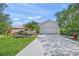 Charming house with neatly maintained lawn and front garden featuring tropical flowers and plants at 8956 Stone Harbour Loop, Bradenton, FL 34212