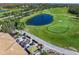 Aerial view of a golf course with outdoor seating and a fire pit, ideal for relaxation and socializing at 8956 Stone Harbour Loop, Bradenton, FL 34212