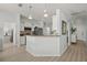 Bright kitchen featuring modern appliances, light wood floors, and a breakfast bar area at 8956 Stone Harbour Loop, Bradenton, FL 34212