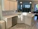 Well-lit kitchen features stainless appliances, white cabinets, and stone backsplash at 8956 Stone Harbour Loop, Bradenton, FL 34212