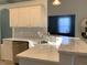 Bright kitchen features modern countertops, stainless steel sink, and white cabinetry at 8956 Stone Harbour Loop, Bradenton, FL 34212