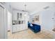 Bright Kitchenette featuring white cabinets, stylish blue velvet loveseat and tile flooring at 8956 Stone Harbour Loop, Bradenton, FL 34212